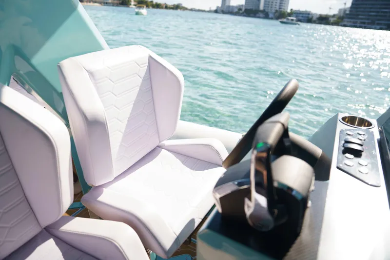Slide: The Image of Luxury Novielli Veloche 2025 boat interior with white seats and steering, on a sunny day. - 6