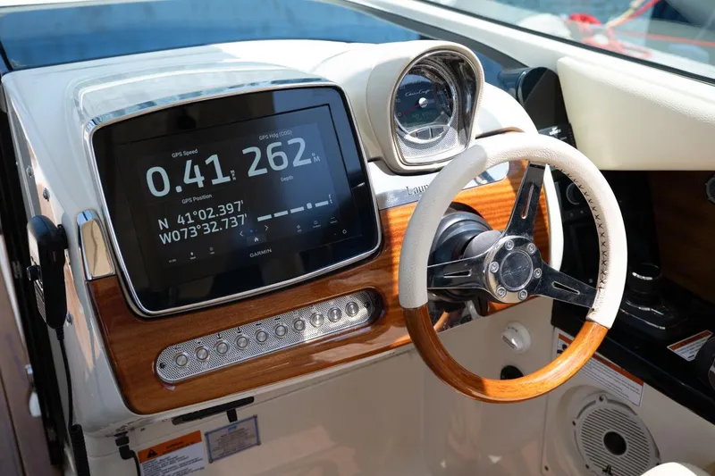 Slide: The Image of 2021 Chris-Craft Launch GT dashboard with wood and chrome accents. - 12
