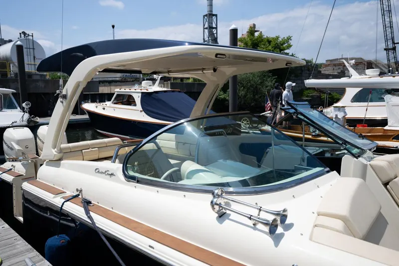 Slide: The Image of 2021 Chris-Craft Launch GT dashboard with cityscape view, featuring modern controls and steering wheel. - 16