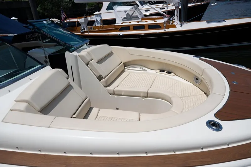 Slide: The Image of 2021 Chris-Craft Launch GT interior with modern dashboard, luxurious seating, and waterfront cityscape view. - 17