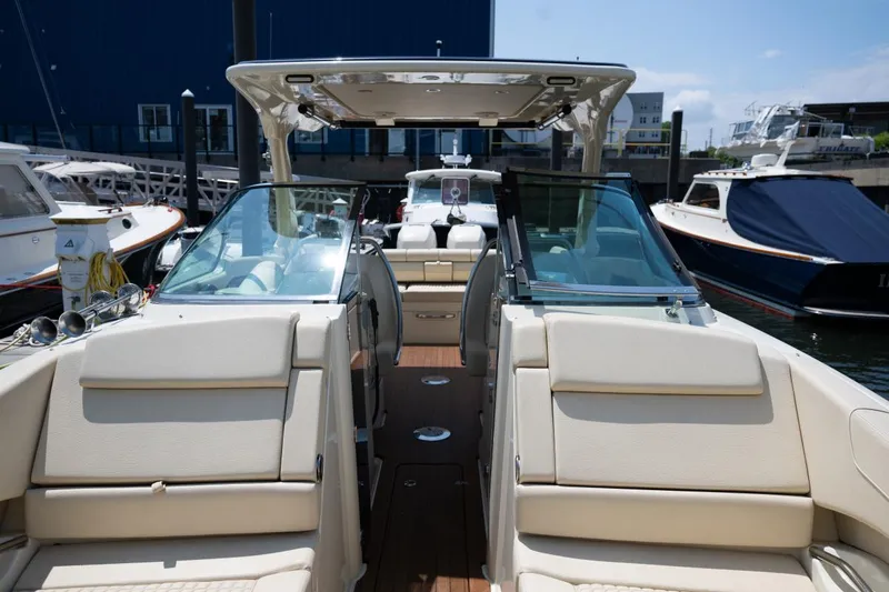 Slide: The Image of 2021 Chris-Craft Launch GT interior with luxurious seating and modern dashboard, docked at marina. - 18