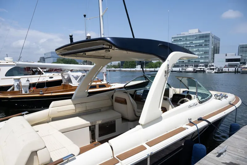 Slide: The Image of 2021 Chris-Craft Launch GT boat docked at marina, featuring sleek design and luxurious seating. - 2