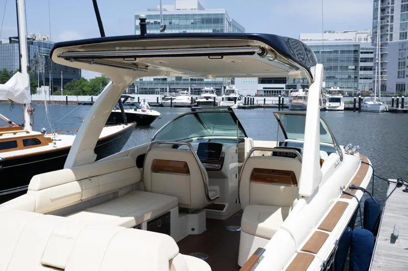 Slide: The Image of 2021 Chris-Craft Launch GT boat with luxurious seating, docked in a modern marina. - 25