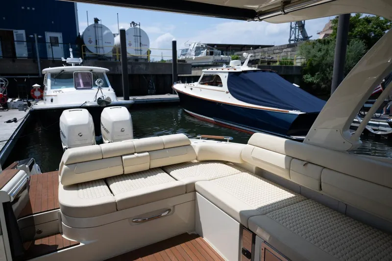 Slide: The Image of 2021 Chris-Craft Launch GT boat with luxurious seating docked at a marina. - 26