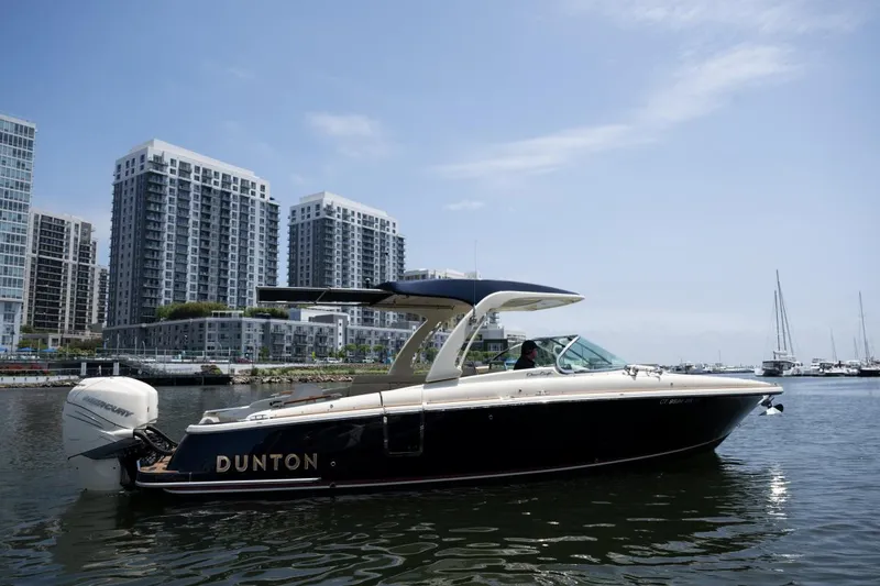 Slide: The Image of 2021 Chris-Craft Launch GT boat on water, city skyline in background. - 3
