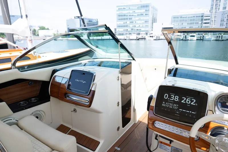 Slide: The Image of 2021 Chris-Craft Launch GT boat interior with modern dashboard and waterfront view. - 36