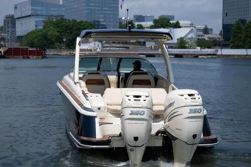 Slide: The Image of 2021 Chris-Craft Launch GT boat with twin 350 engines on a city waterfront. - 5