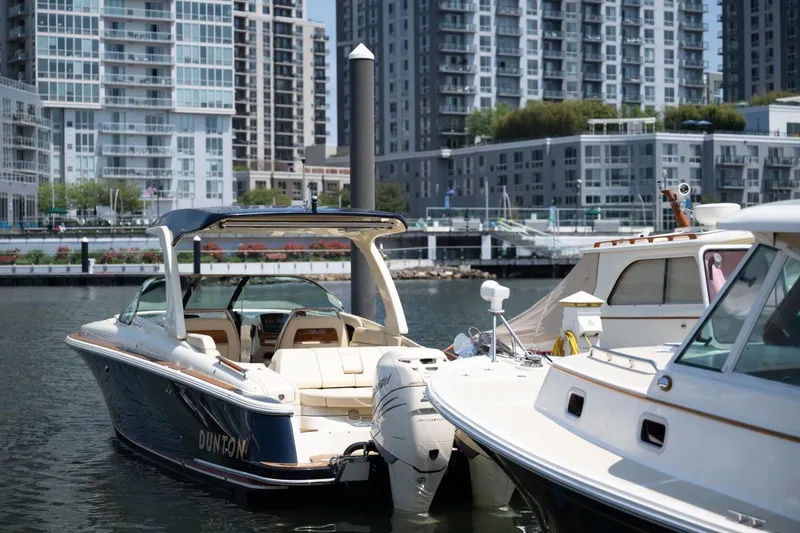 Slide: The Image of 2021 Chris-Craft Launch GT boat on water, city skyline in background. - 7