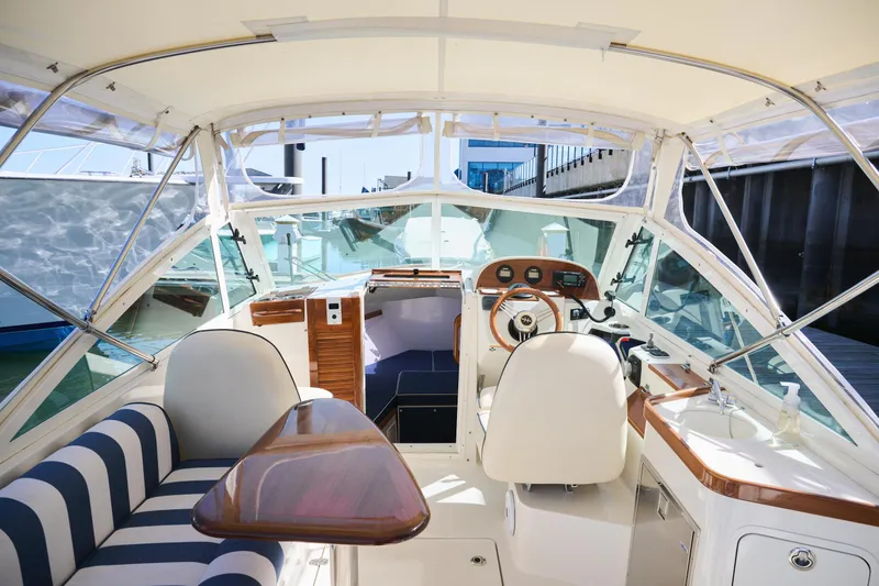 Slide: The Image of 2016 Hunt Yachts Harrier 26 interior with striped seating and wooden accents. - 15