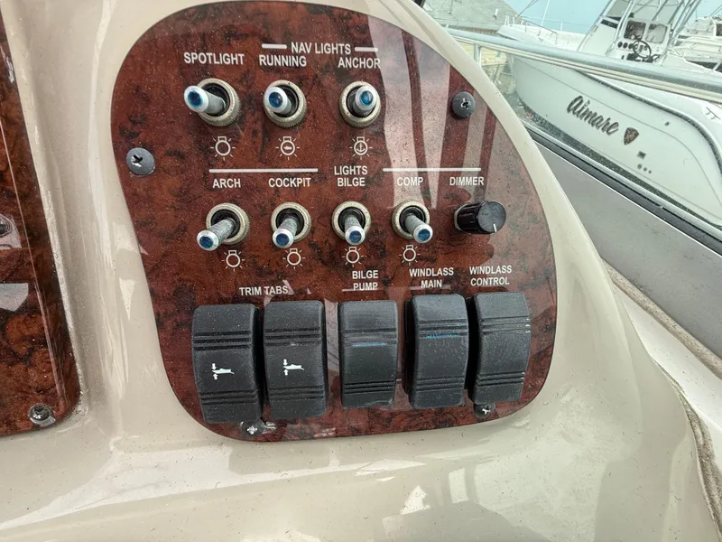 Slide: The Image of Control panel of a 2006 Sea Ray 300 Sundancer boat with various switches and dials. - 10
