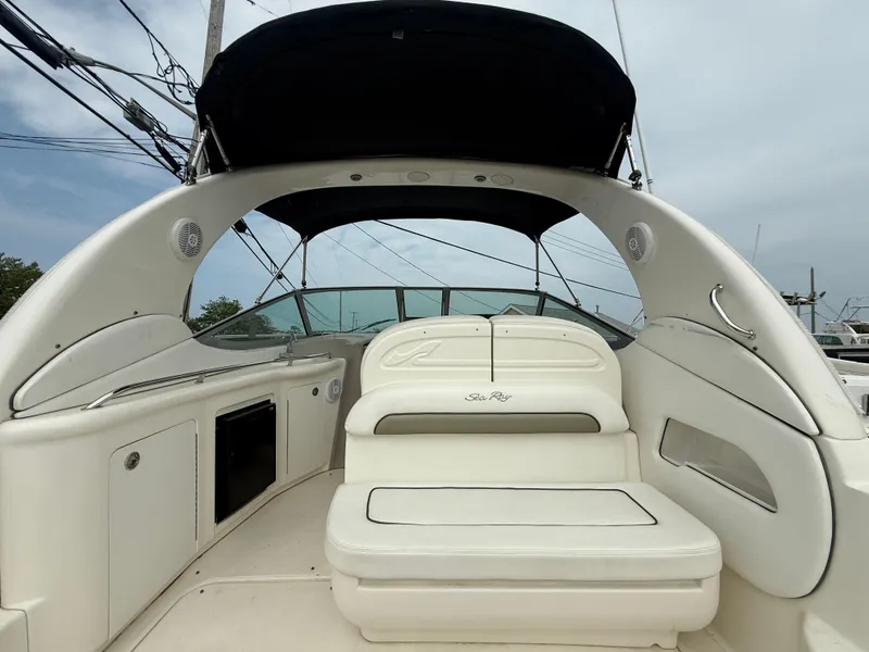 Slide: The Image of 2006 Sea Ray 300 Sundancer boat interior with seating and canopy. - 14