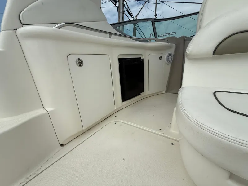 Slide: The Image of 2006 Sea Ray 300 Sundancer interior with white seating and storage compartments. - 15