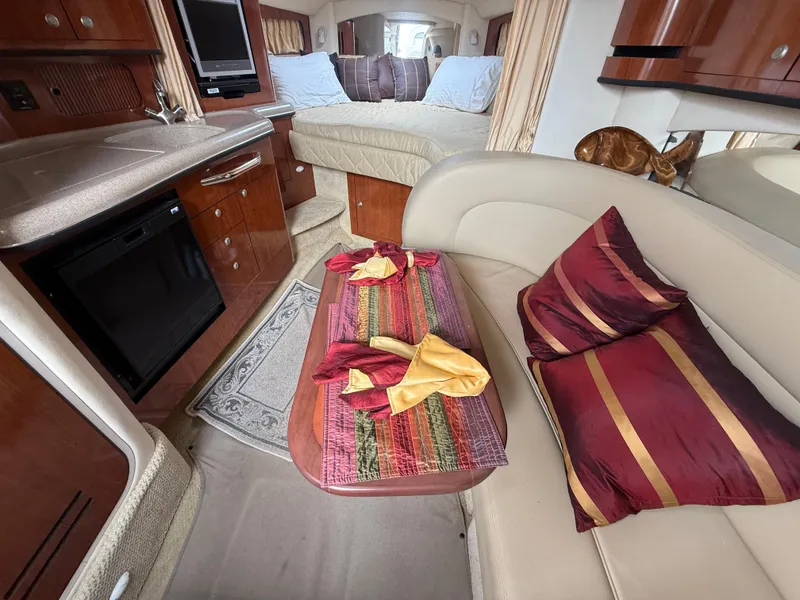 Slide: The Image of Interior of 2006 Sea Ray 300 Sundancer with cozy seating and elegant decor. - 19