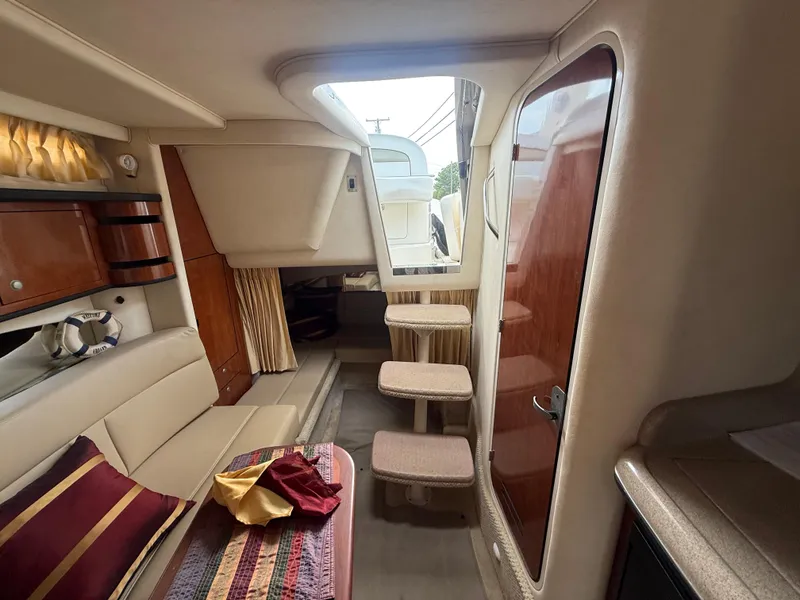 Slide: The Image of Interior of 2006 Sea Ray 300 Sundancer yacht, featuring cozy seating and elegant wood finishes. - 20