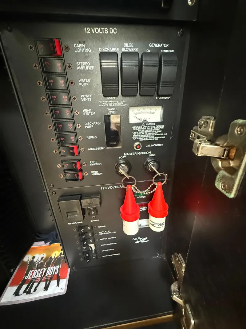 Slide: The Image of Electrical panel of a 2006 Sea Ray 300 Sundancer boat with switches and controls. - 23