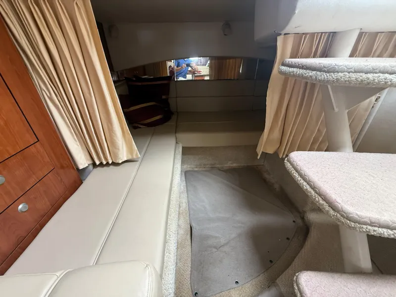 Slide: The Image of Interior of 2006 Sea Ray 300 Sundancer with beige seating and carpeted stairs. - 26