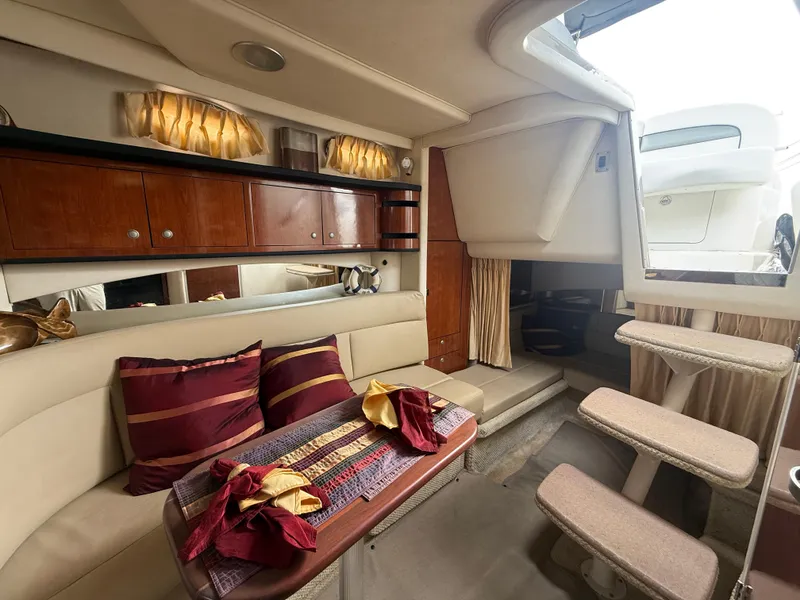 Slide: The Image of Interior of 2006 Sea Ray 300 Sundancer yacht with elegant seating and wooden cabinetry. - 28