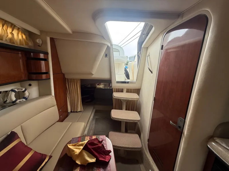 Slide: The Image of Interior of 2006 Sea Ray 300 Sundancer boat with seating and wooden accents. - 29