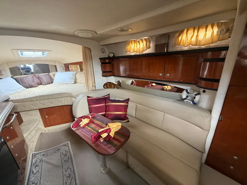 Slide: The Image of Interior of 2006 Sea Ray 300 Sundancer yacht with cozy seating and elegant wood cabinetry. - 33