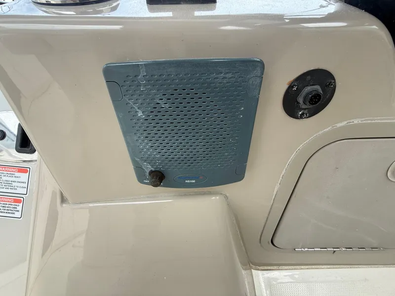 Slide: The Image of Speaker panel on a 2006 Sea Ray 300 Sundancer boat dashboard. - 36