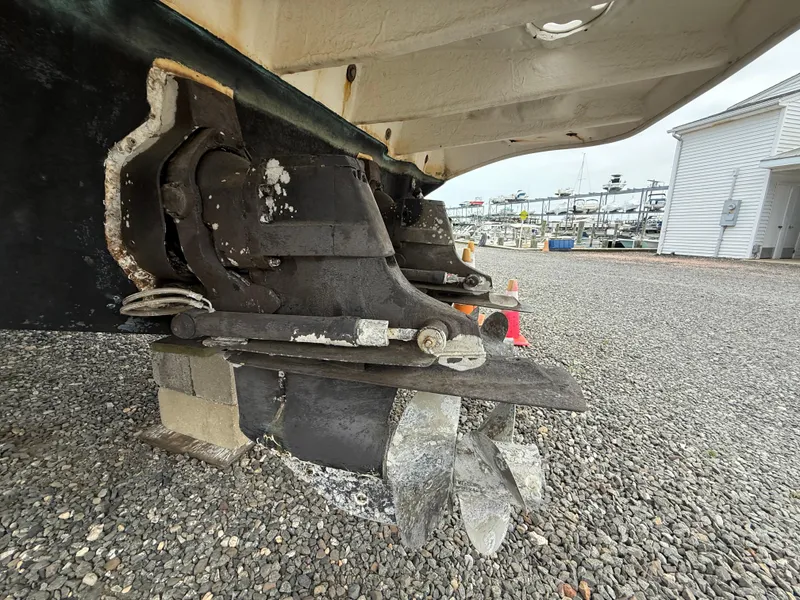 Slide: The Image of 2006 Sea Ray 300 Sundancer boat propeller and stern drive on gravel surface. - 48