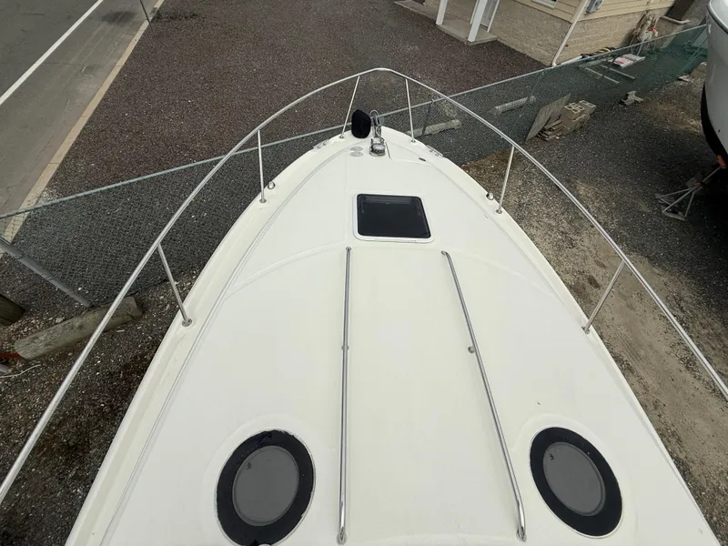 Slide: The Image of 2006 Sea Ray 300 Sundancer boat deck, aerial view, docked on gravel. - 6