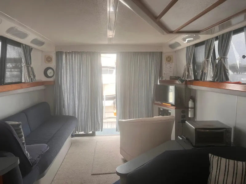 Slide: The Image of Interior of 1990 Luhrs 3400 Motor Yacht with cozy seating and nautical decor. - 15