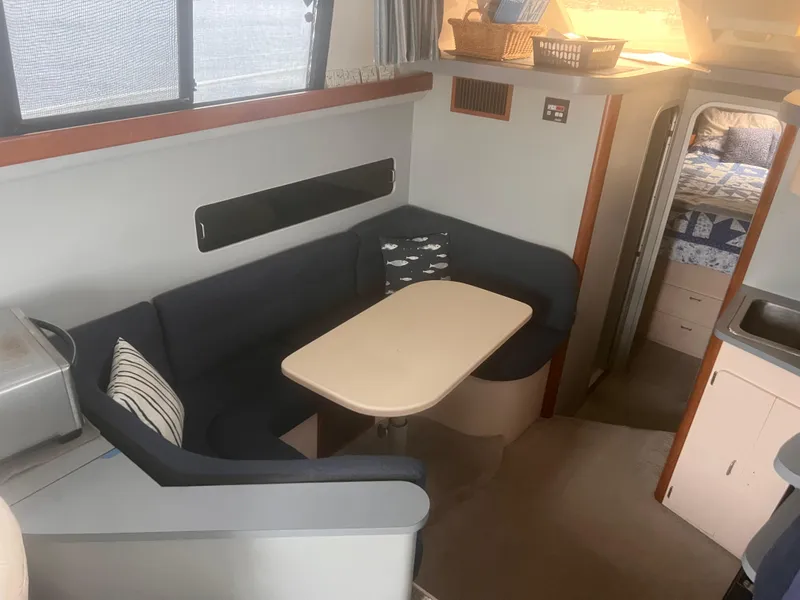 Slide: The Image of 1990 Luhrs 3400 Motor Yacht interior with cozy dining area and modern furnishings. - 17