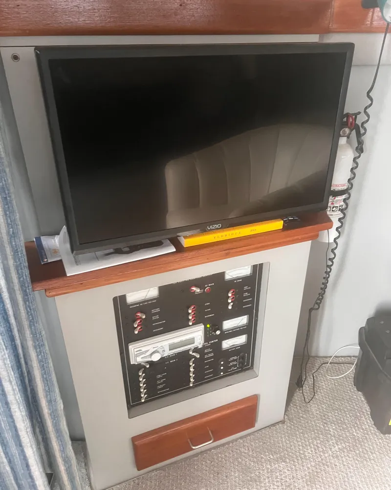 Slide: The Image of 1990 Luhrs 3400 Motor Yacht interior with TV and control panel. - 20