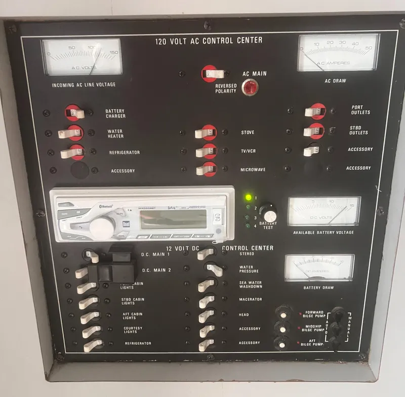 Slide: The Image of Control panel of a 1990 Luhrs 3400 Motor Yacht, featuring AC and DC switches. - 22