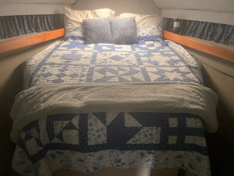 Slide: The Image of Cozy bed with blue quilt in 1990 Luhrs 3400 Motor Yacht cabin. - 23