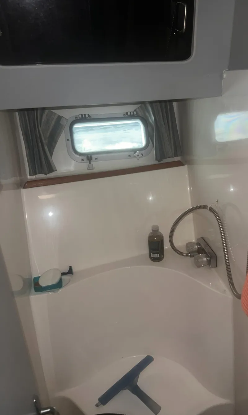 Slide: The Image of 1990 Luhrs 3400 Motor Yacht bathroom with shower and window. - 26
