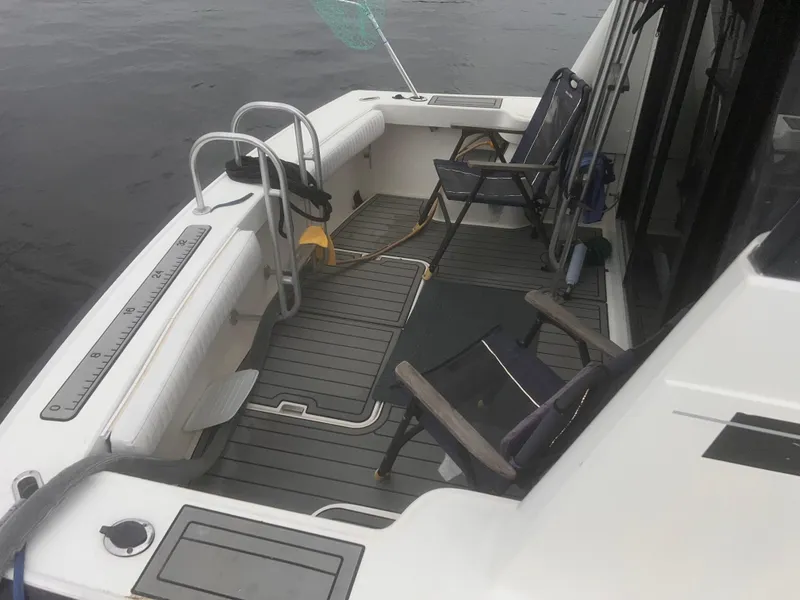 Slide: The Image of 1990 Luhrs 3400 Motor Yacht deck with chairs and fishing gear. - 3