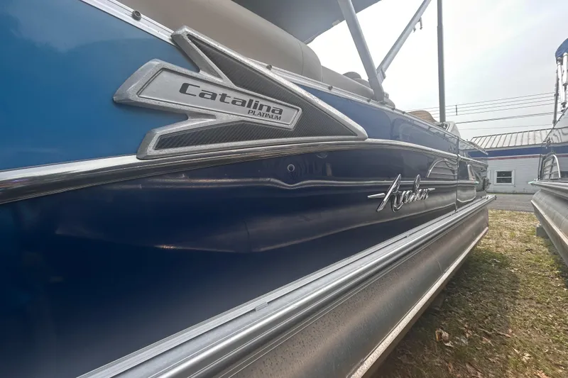 Slide: The Image of 2023 Avalon 2585 Catalina boat, blue exterior, side view with branding details. - 18