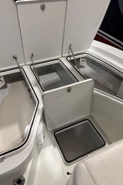 Slide: The Image of 2018 Hell's Bay Estero 24 boat storage compartments with open hatches. - 11