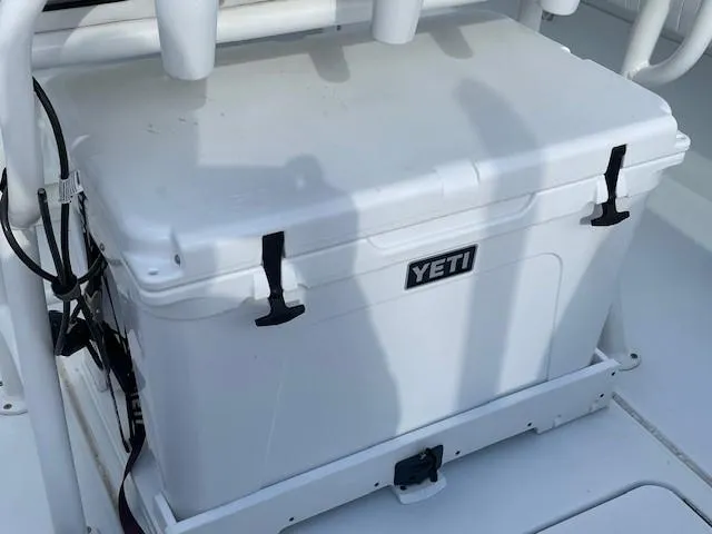 Slide: The Image of YETI cooler on 2018 Hell's Bay Estero 24 boat deck, secured with straps. - 9