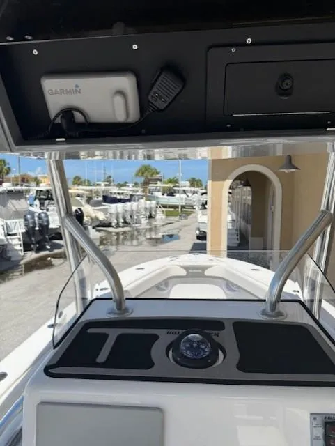 Slide: The Image of 2024 Bluewater 23 boat dashboard with Garmin equipment, marina view in background. - 10