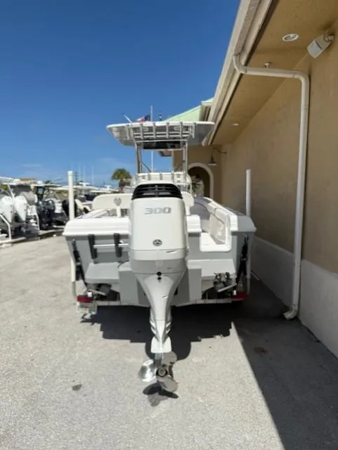Slide: The Image of 2024 Bluewater 23 boat with powerful 300 HP engine, docked under clear blue sky. - 11