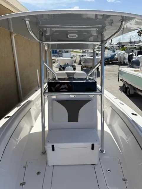 Slide: The Image of 2024 Bluewater 23 boat with T-top and spacious deck in marina setting. - 7
