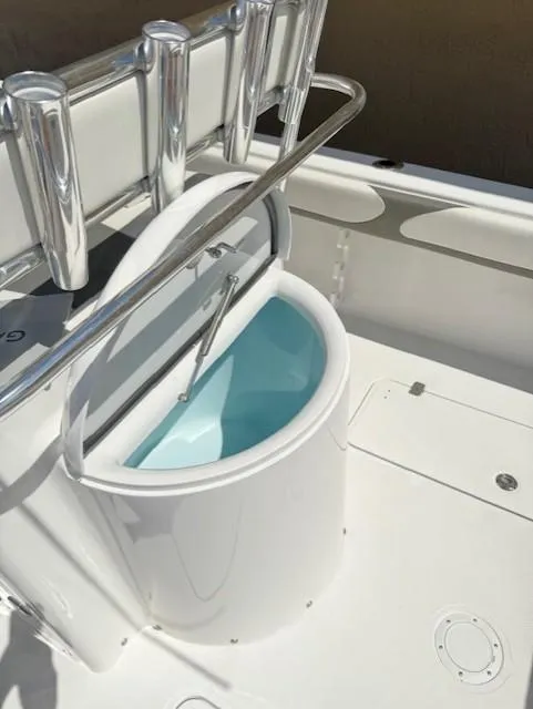Slide: The Image of 2024 Bluewater 23 boat with open livewell and rod holders. - 8