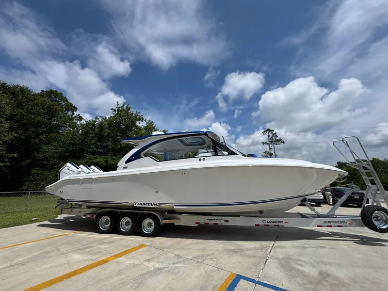 Slide: The Image of 2026 Fountain 39 DX boat on trailer under cloudy sky, parked outdoors. - 10