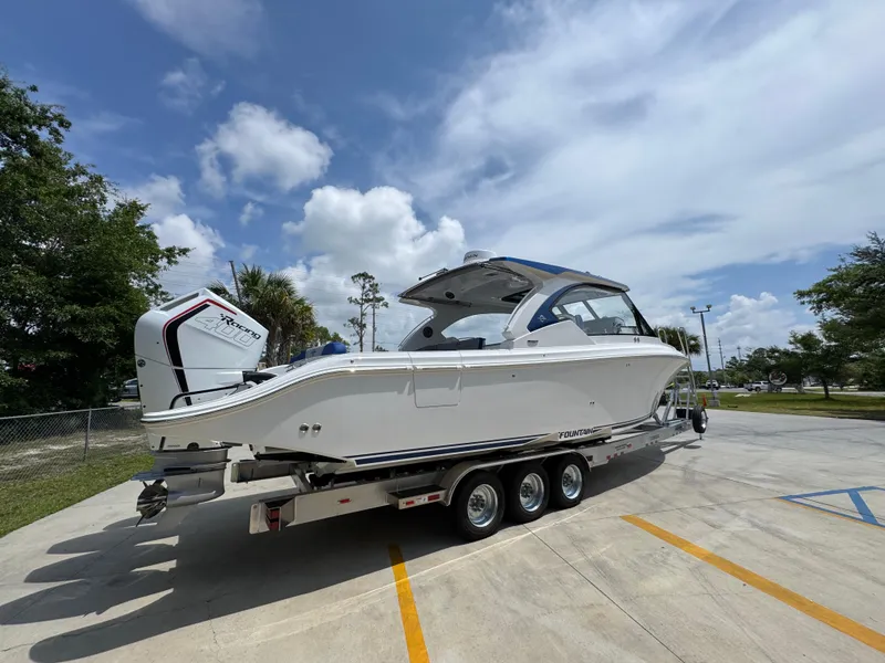 Slide: The Image of 2026 Fountain 39 DX boat on trailer under blue sky. - 13