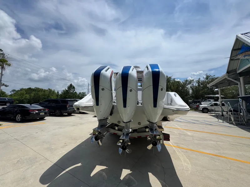 Slide: The Image of 2026 Fountain 39 DX boat with triple outboard engines in a parking lot. - 16