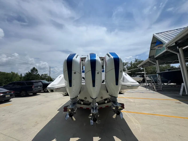 Slide: The Image of 2026 Fountain 39 DX boat with triple outboard engines in a parking area. - 17