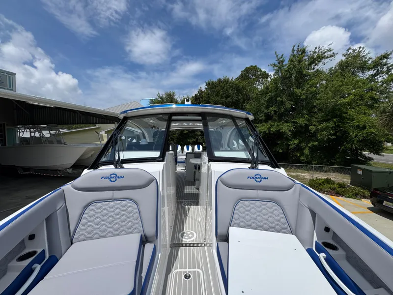 Slide: The Image of 2026 Fountain 39 DX boat with sleek design and spacious seating under a clear sky. - 23