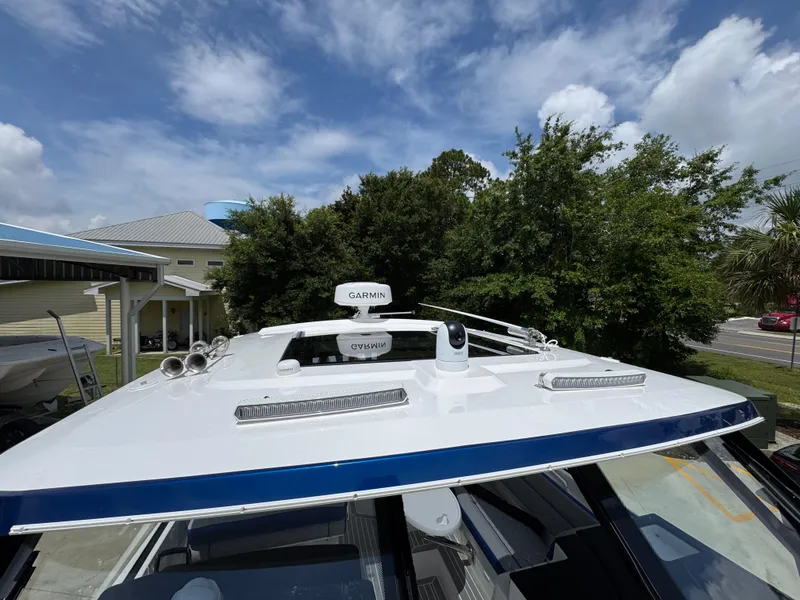 Slide: The Image of 2026 Fountain 39 DX boat with Garmin radar, docked under a partly cloudy sky. - 24