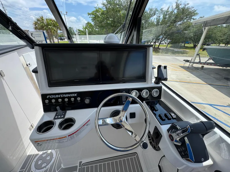 Slide: The Image of 2026 Fountain 39 DX boat cockpit with steering wheel and control panel. - 27