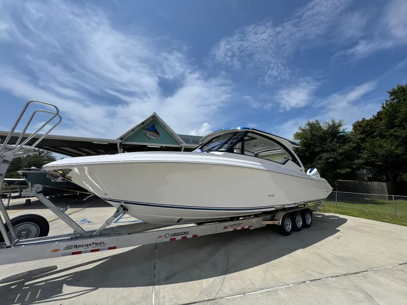 Slide: The Image of 2026 Fountain 39 DX boat on trailer under clear sky. - 3