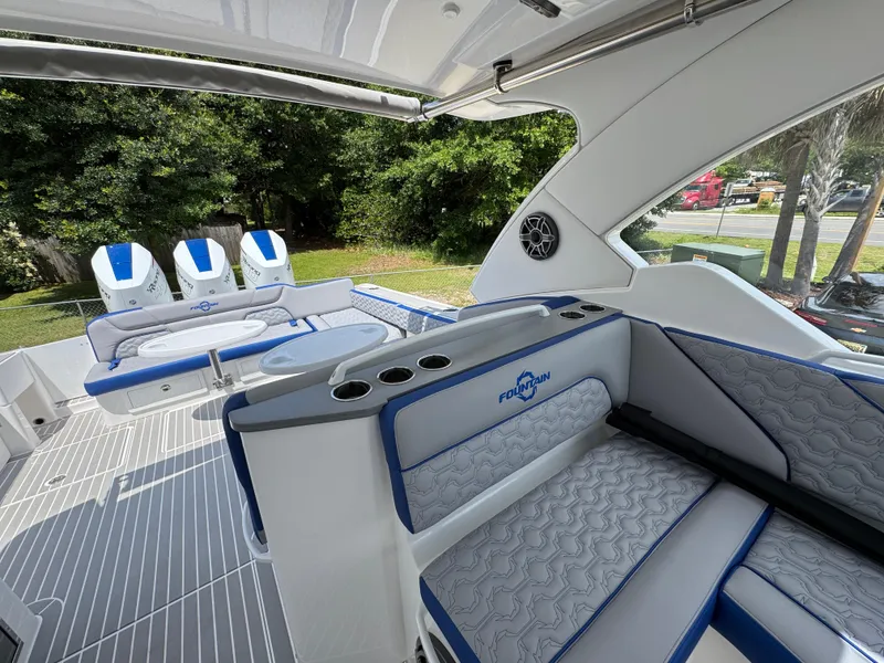 Slide: The Image of 2026 Fountain 39 DX boat interior with seating and triple outboard motors. - 33