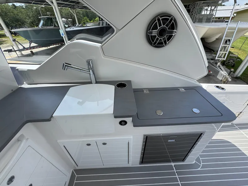 Slide: The Image of Modern boat kitchen area on 2026 Fountain 39 DX, featuring sink, storage, and sleek design. - 35